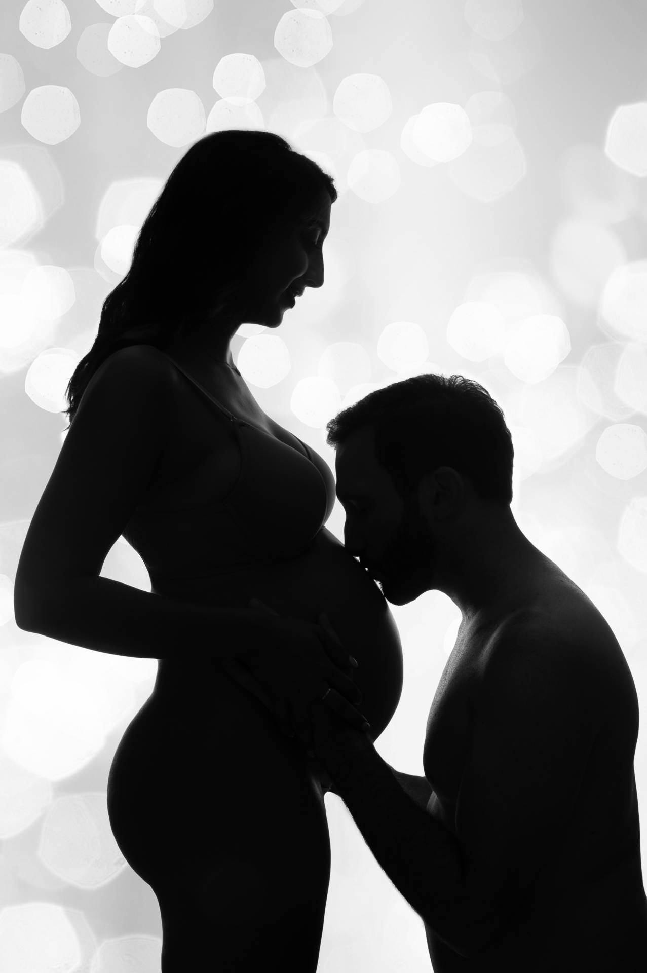 pregnant woman and her husband silhouette.