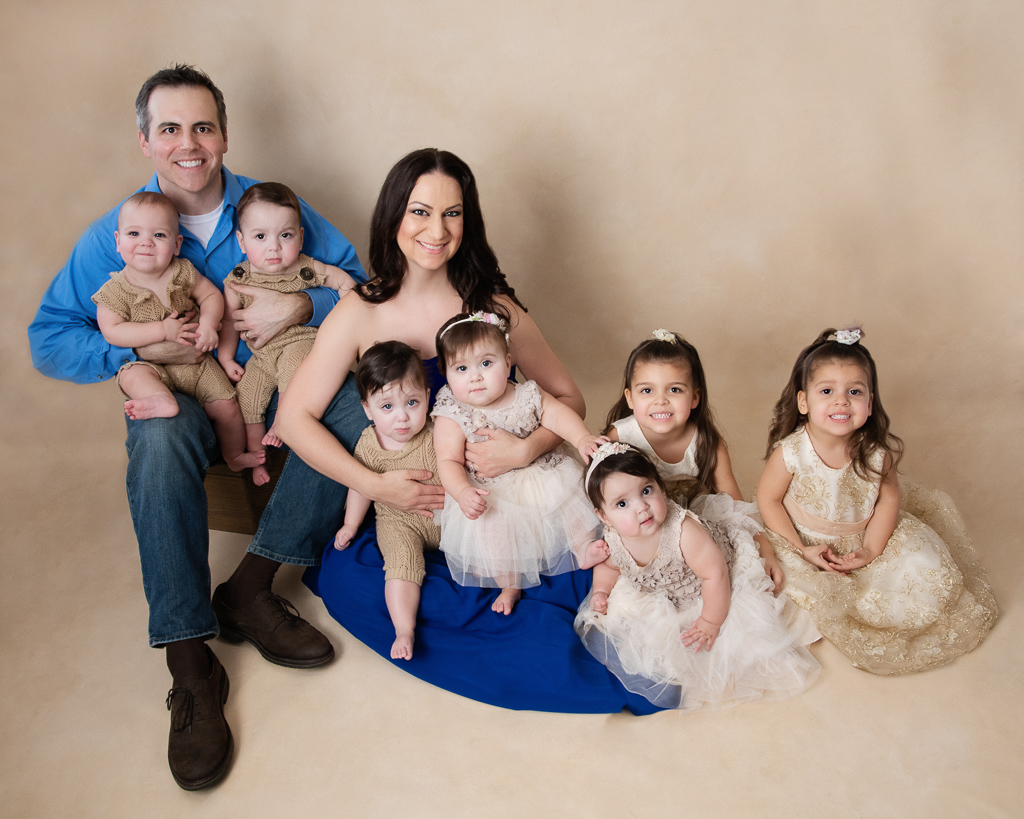Family of 7. Dad, mom, and their 5 children. 5 one year old, two older girls around 4 year old.