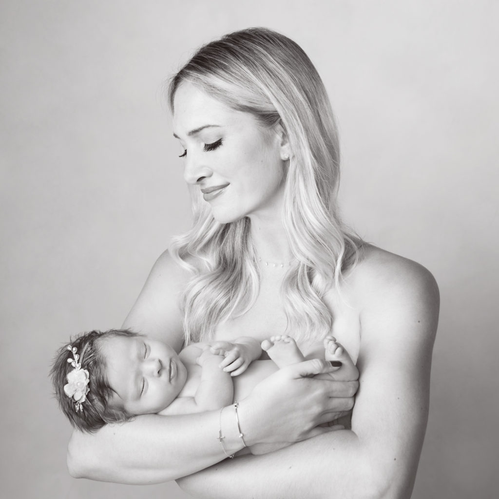 Mom holding her newborn girl. Black and white image.