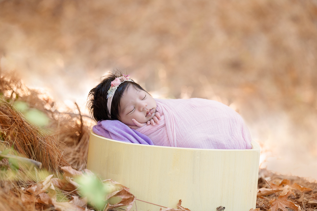 newborn baby girl outdoors after retouching