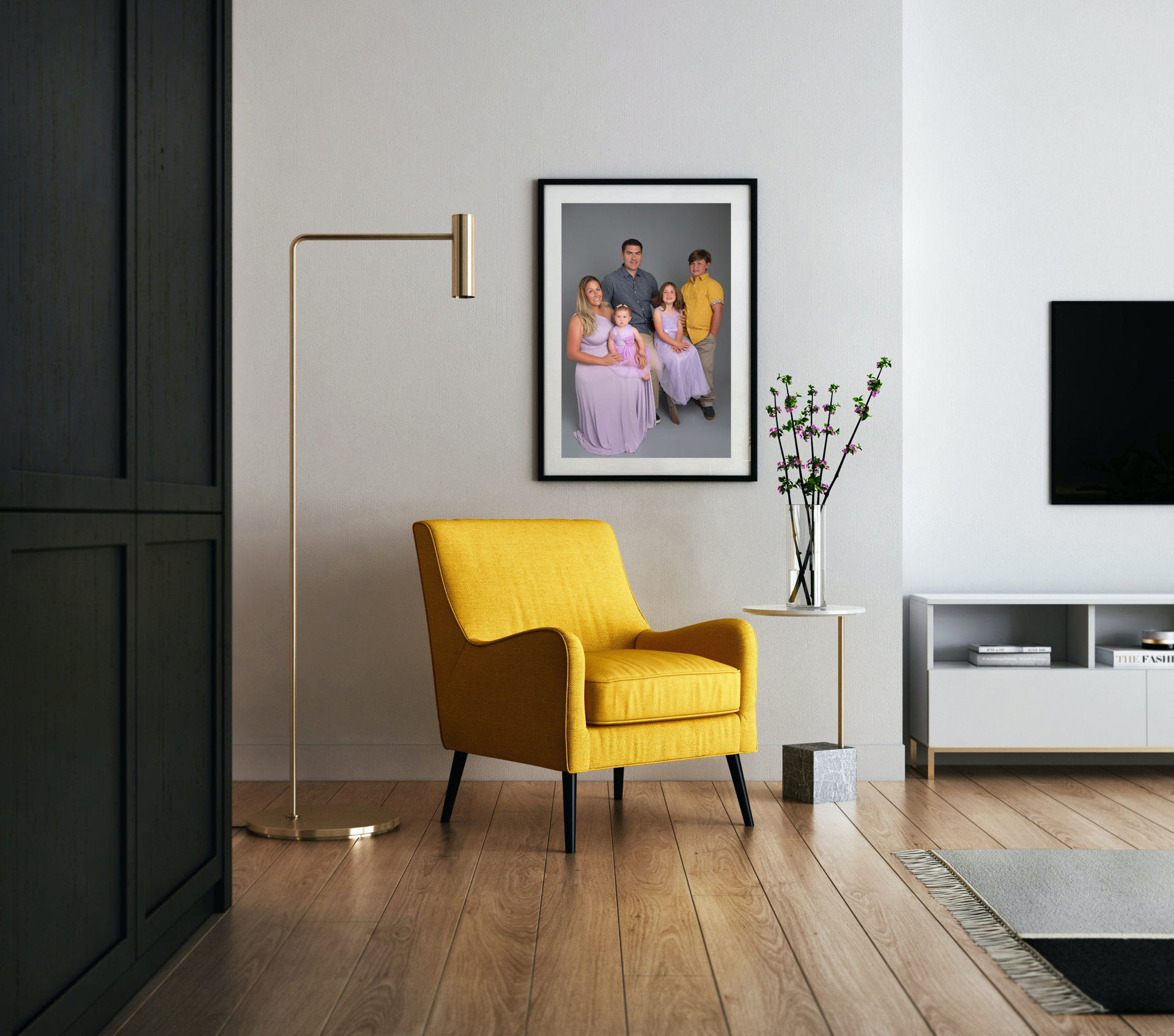 Yellow arm chair with a picture hanging showing a family