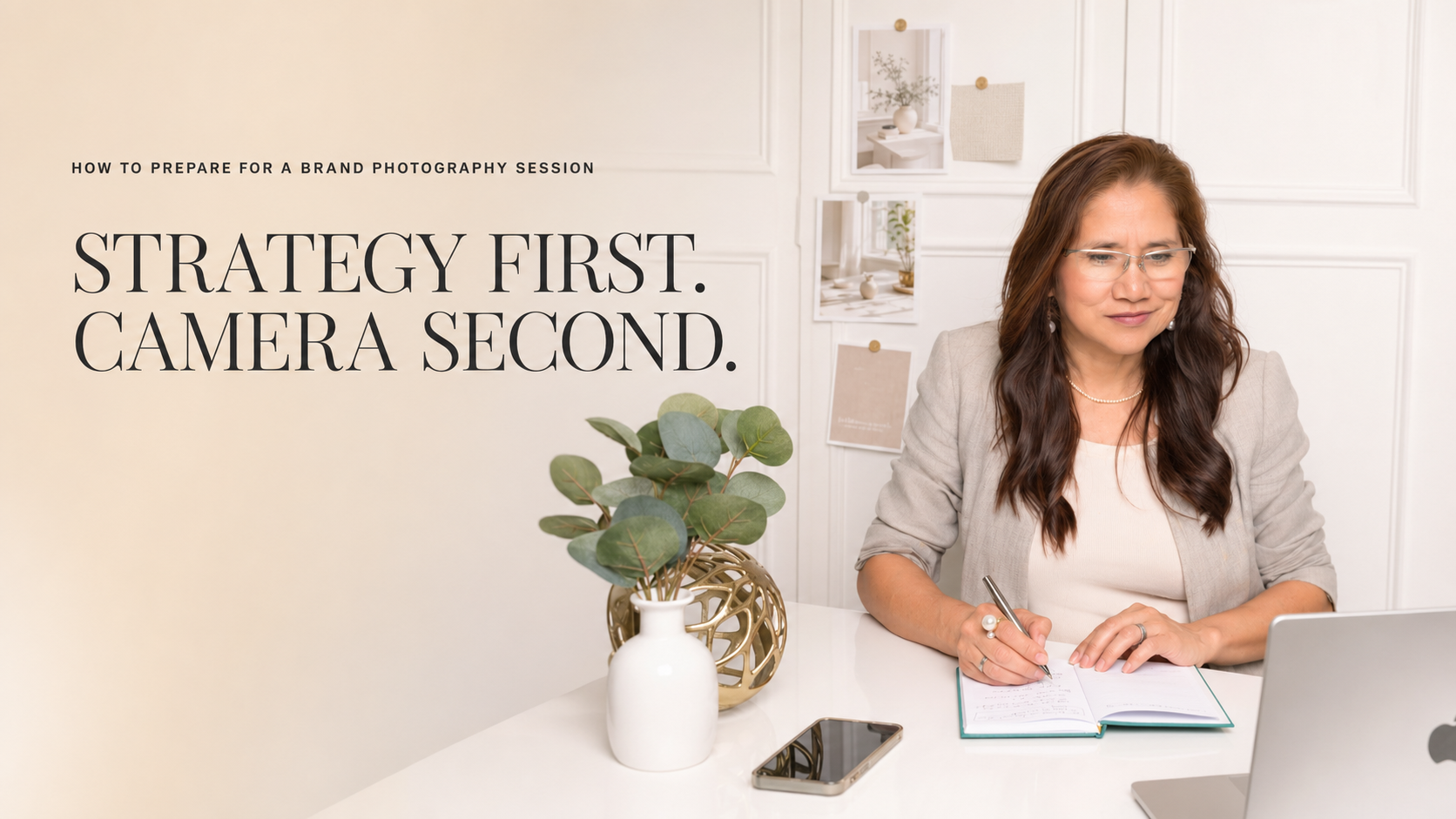 Personal branding photo: A woman with long hair and glasses writes in a notebook at her desk with a phone and plant nearby; text reads, "Strategy first. Camera second." Neutral office setting.