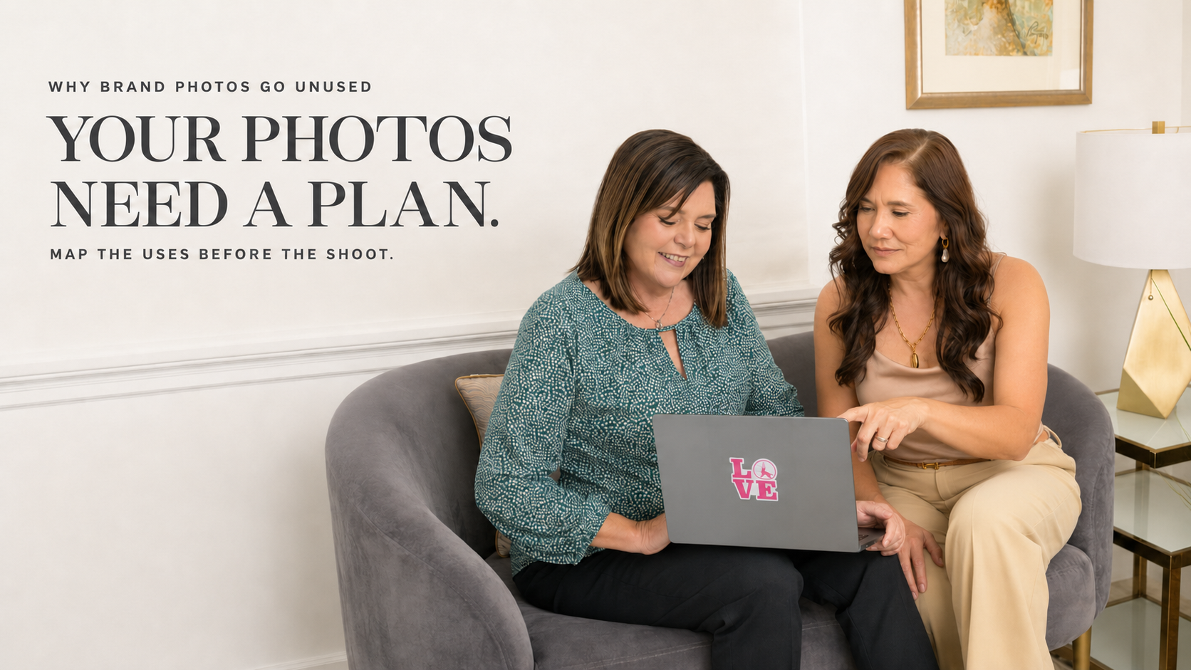 Personal branding photo: Two women sit on a gray sofa in the San Francisco Bay Area, looking at a laptop with a LOVE sticker; text beside them says, “Your photos need a plan. Map the uses before the shoot.” Framed art and a lamp are behind them.