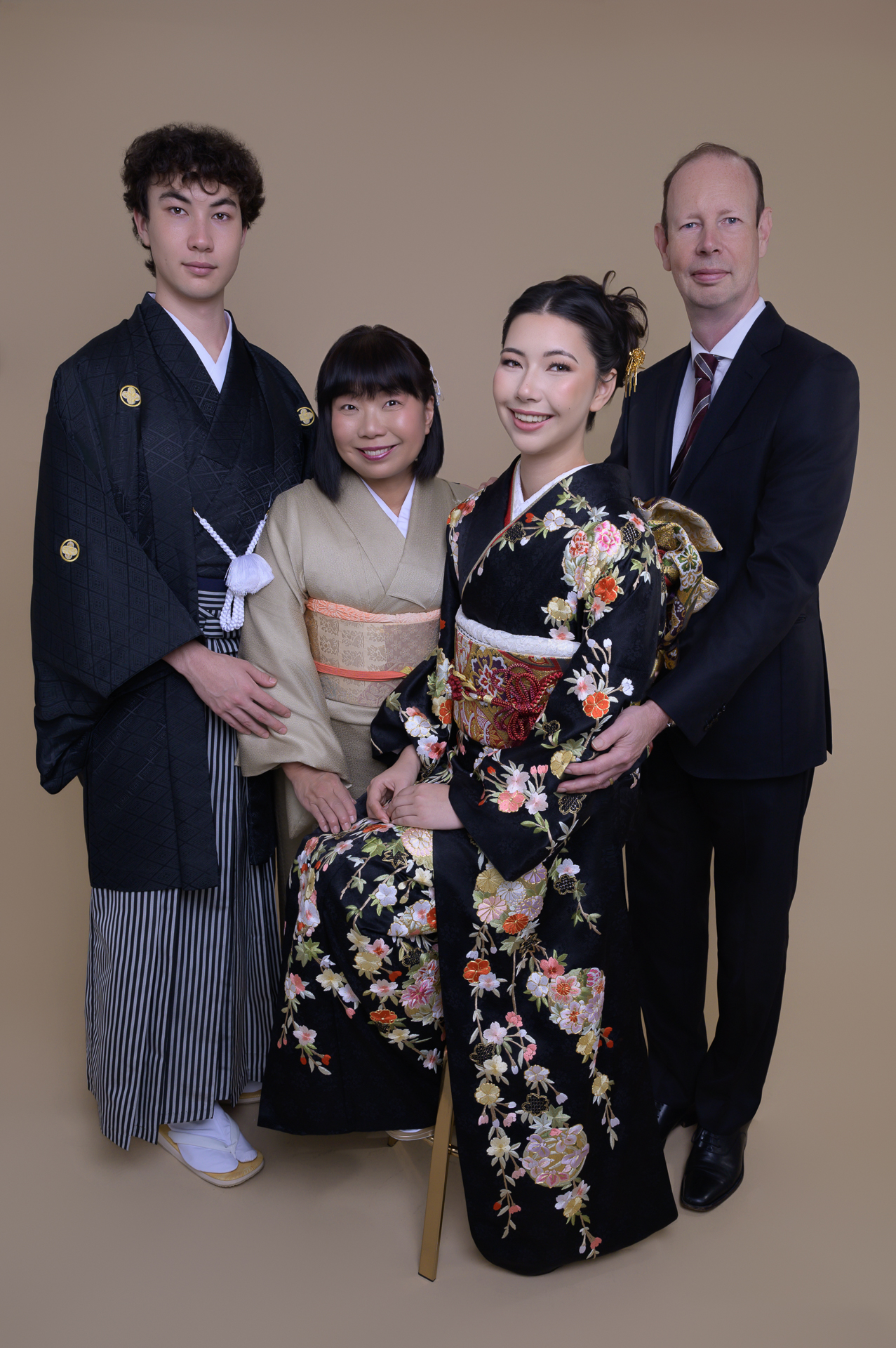 SF Bay Area: Family Session Four members of the Coward family pose together, with a young woman in a black floral kimono beside relatives in traditional and formal attire.